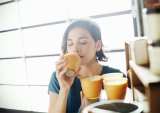 woman smelling candles