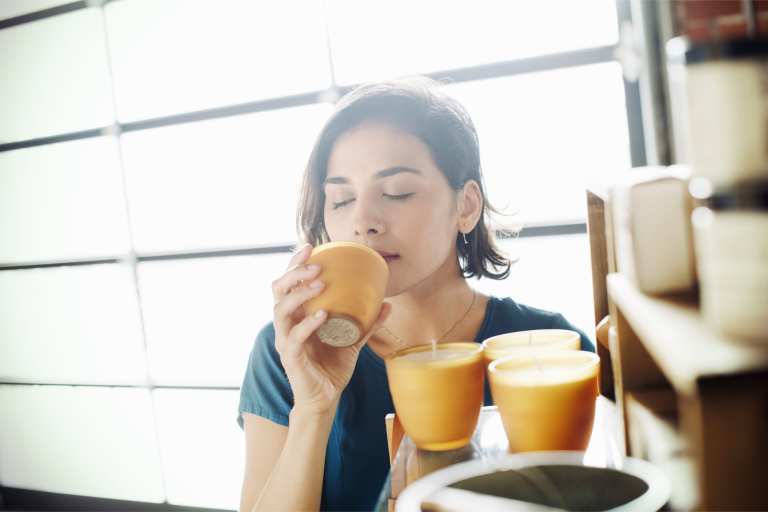 woman smelling candles