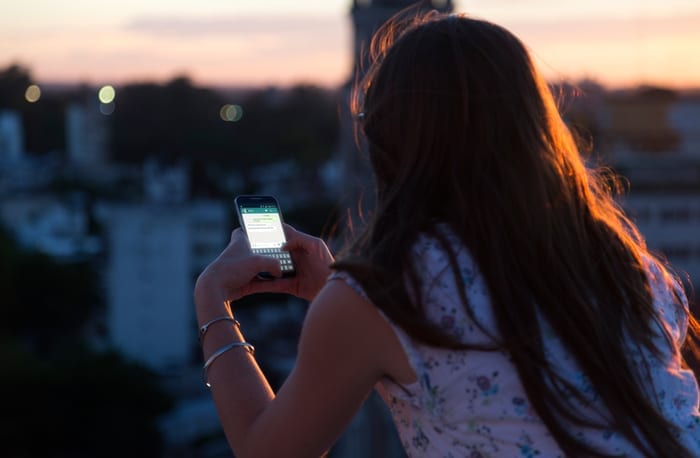 woman messaging on smartphone