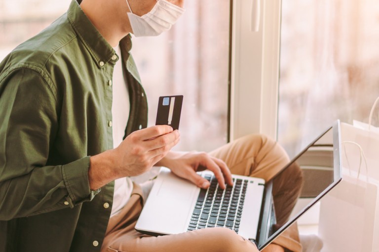 man online shopping wearing mask