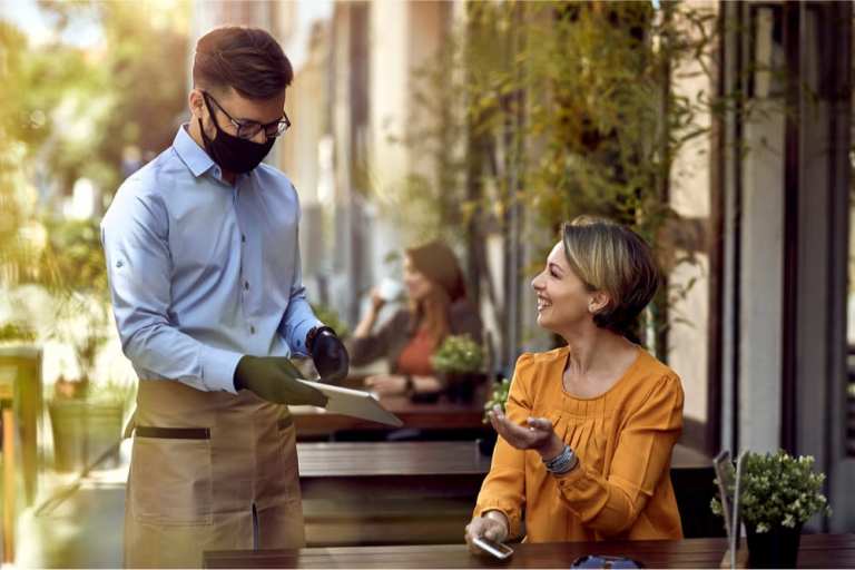 waiter and customer in face masks