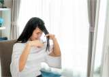 woman cutting her own hair