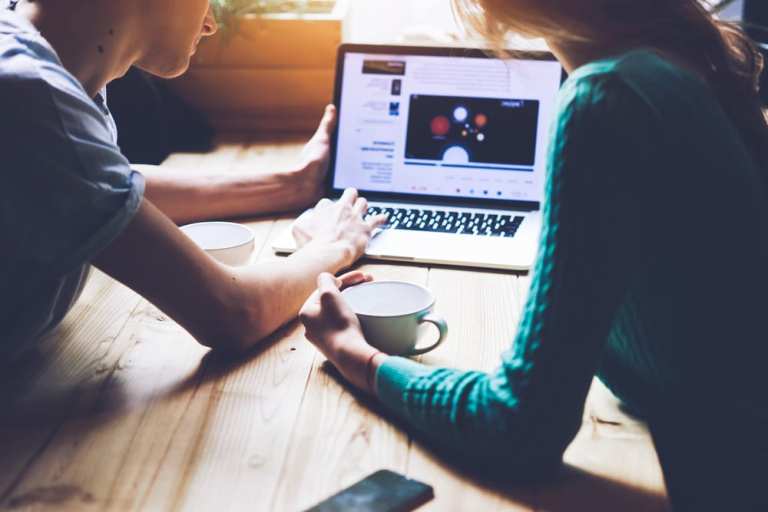 two people watching video on laptop