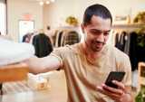 man in store using smartphone