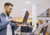 man shopping for laptop computer