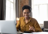 woman working on laptop and calculator