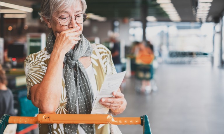 grocery shopper looking at receipt