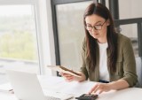 businesswoman adding up expenses