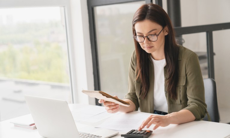 businesswoman adding up expenses