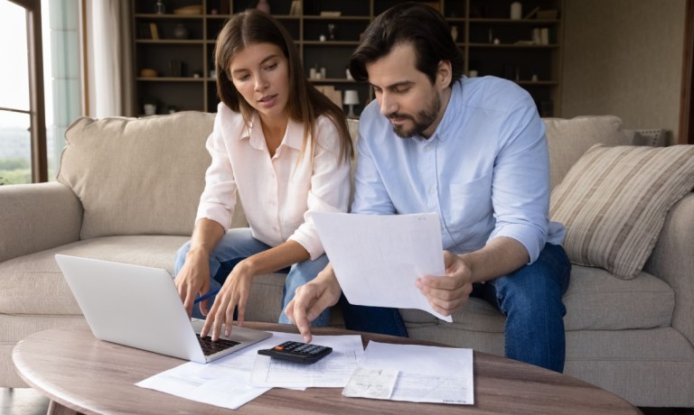 millennial couple paying bills