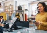 woman paying at clothing store