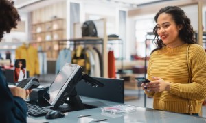 woman paying at clothing store