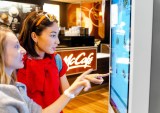 two people using fast food self-service kiosk