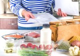 person in kitchen with meal kit