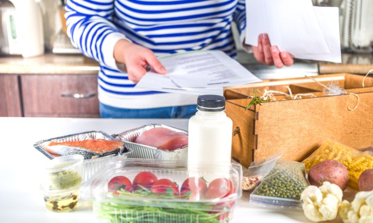 person in kitchen with meal kit