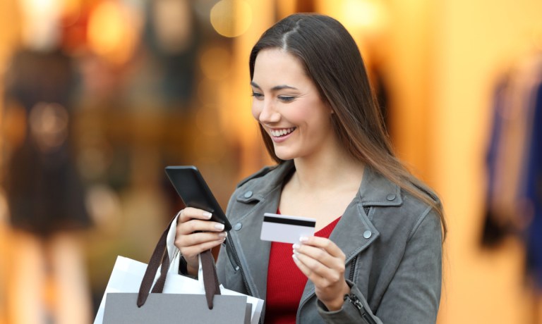 woman with credit card and phone