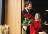 man giving roses to woman