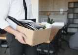 laid-off employee leaving office with box