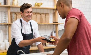 man paying with credit card