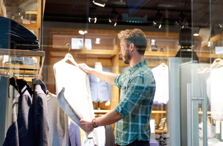 man shopping in clothing store