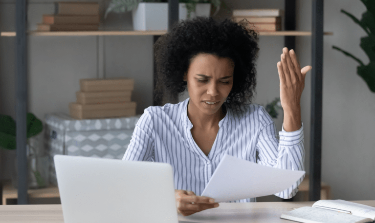 woman at laptop upset