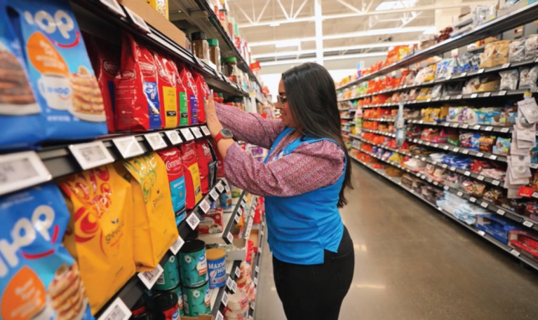 Walmart employee stocking shelves