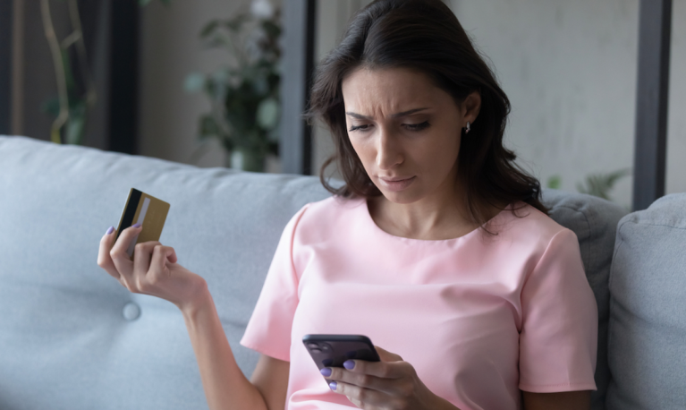 worried woman with credit card