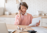 woman on phone with bills