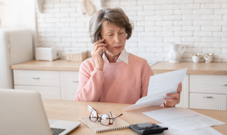 woman on phone with bills