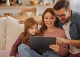 family looking at digital tablet