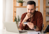 man looking at credit card