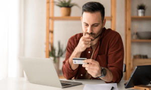 man looking at credit card